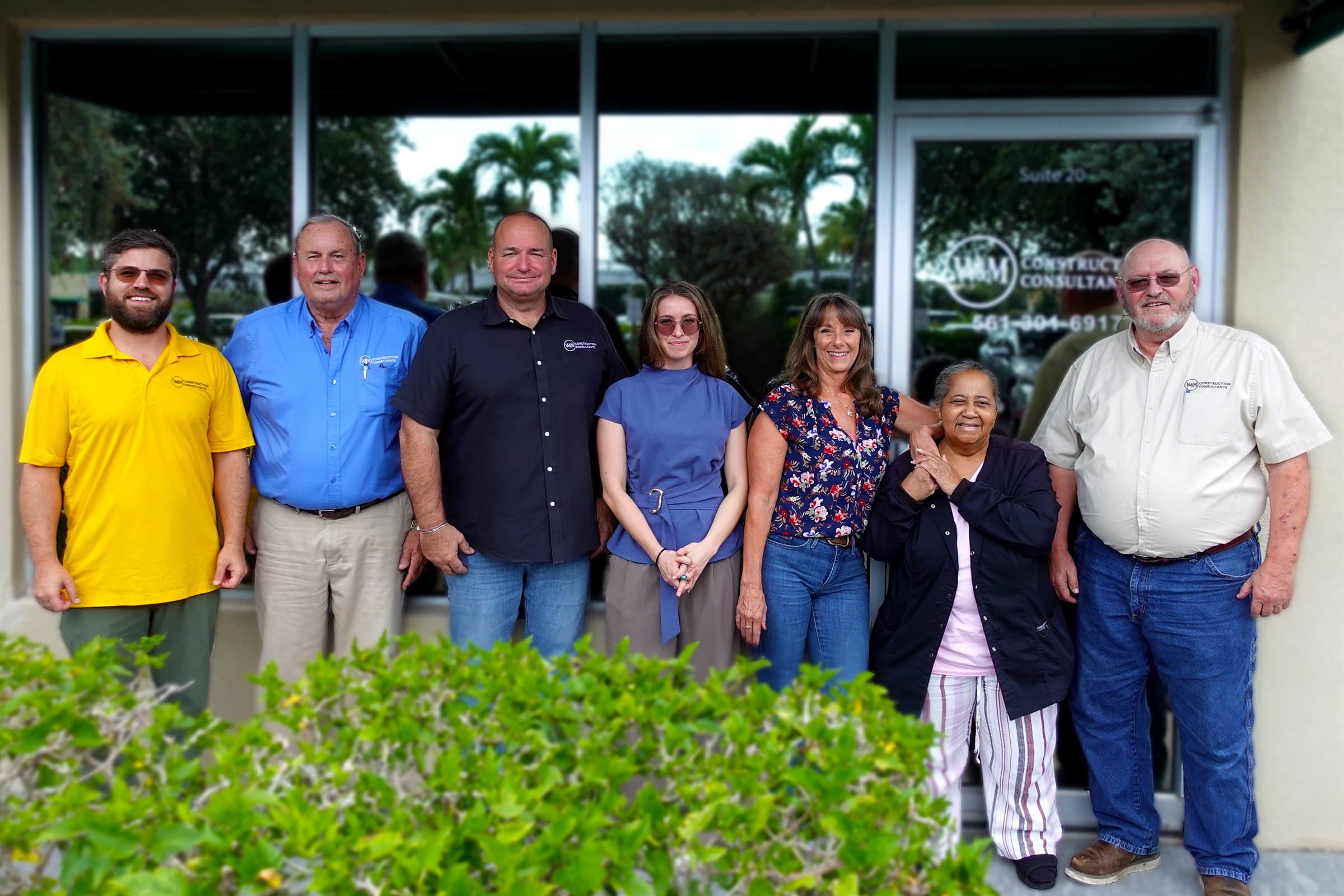 The W&M Construction Consultants team standing outside the firm office.