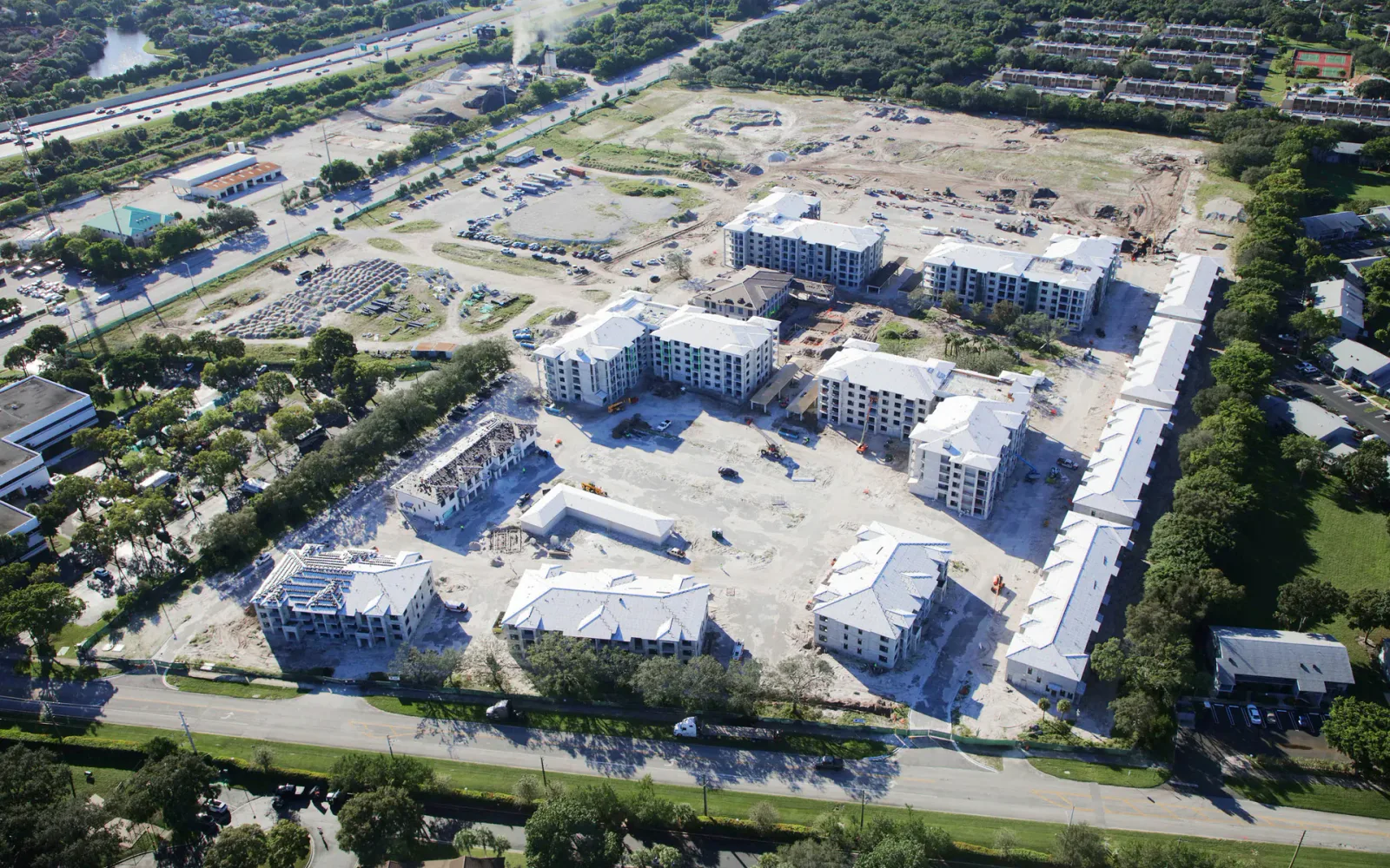 Active multifamily construction site showing remaining work and completion exposure.